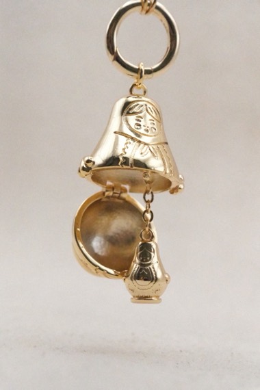Gold nesting doll charm, opened to show the smaller doll inside