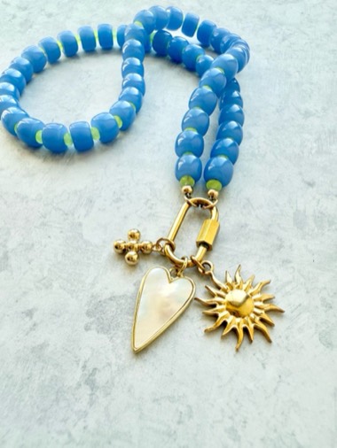 Electric charm keeper, blue and lime beads with a gold carabiner holding a mother of pearl heart and a sun charm